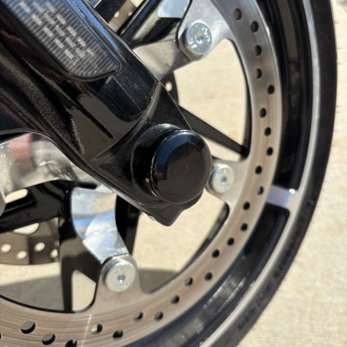 Black HOGWORKZ® Front Axle Covers for Harley® Touring on harley