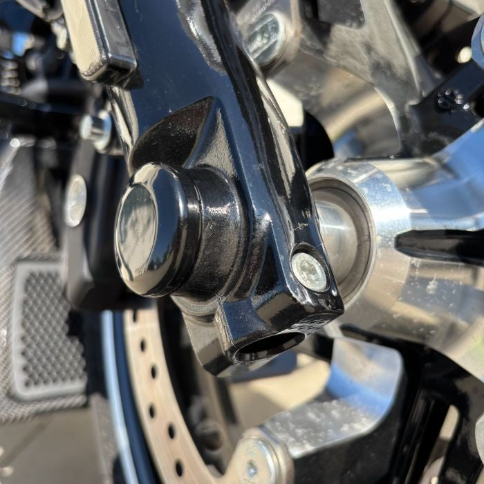 Black HOGWORKZ® Front Axle Covers for Harley® Touring close up