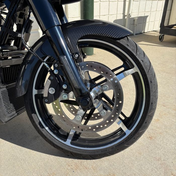 Black HOGWORKZ® Front Axle Covers for Harley® Touring on bike