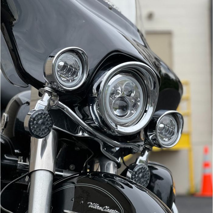 Chrome-plated visor style headlight trim ring. Direct bolt-on install for 7" headlight from HOGWORKZ on electra glide angle