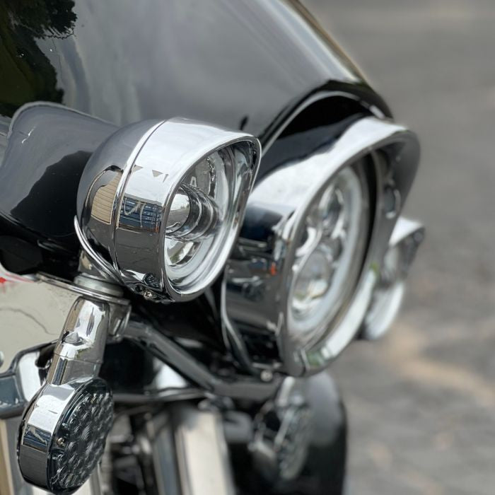 Chrome-plated visor style headlight trim ring. Direct bolt-on install for 7" headlight from HOGWORKZ on electra glide side vi